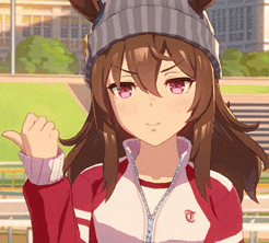 a girl wearing a beanie and a jacket with the letter t on the front