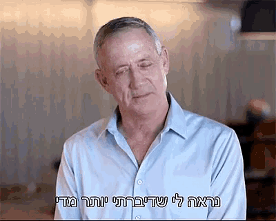 a man wearing a blue shirt has a foreign language written on his shirt