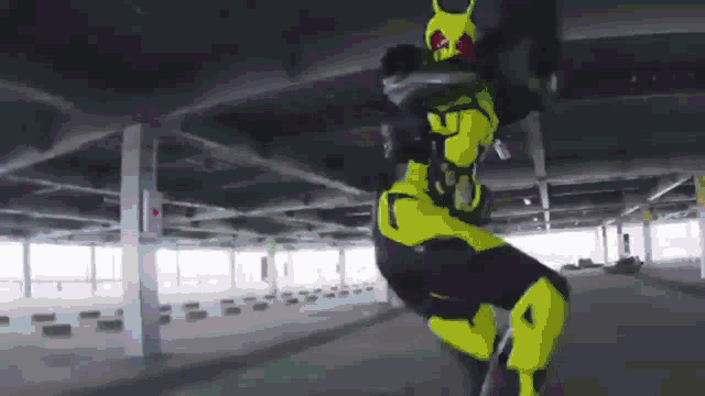 a person in a yellow and black superhero costume is doing a trick on a motorcycle in a parking garage .