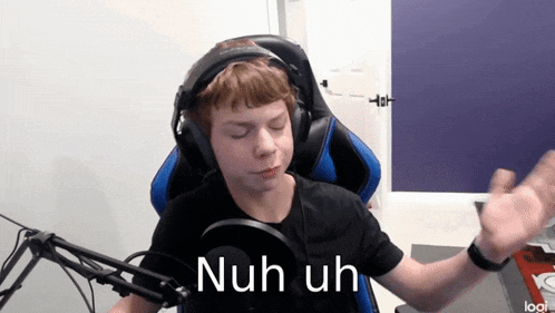 a boy wearing headphones is sitting in front of a microphone and says nuh uh