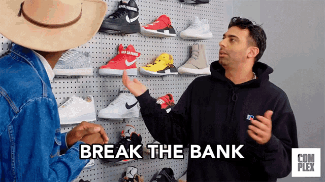 two men are standing in front of a wall of shoes and the words break the bank are on the screen