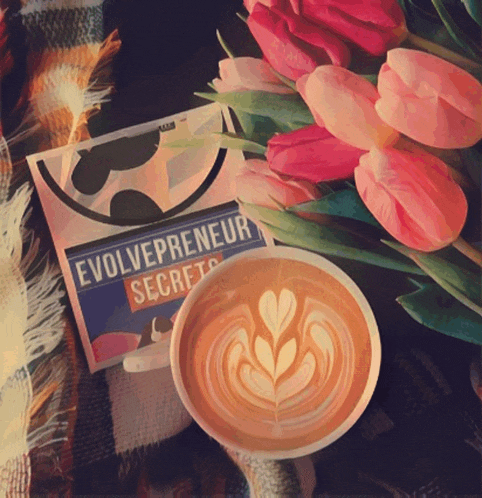 a cup of coffee sits next to a book titled evolvepreneur secrets