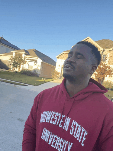 a man wearing a red hoodie that says midwest state university