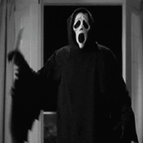 a man in a scream mask is holding a knife in his hand .