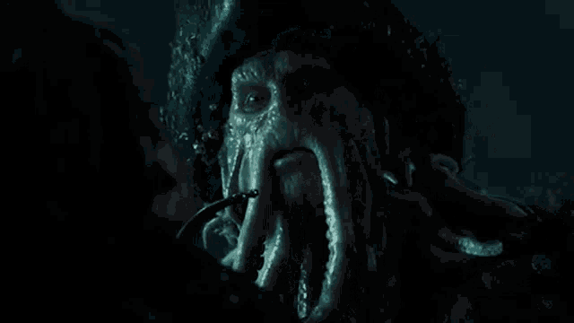 a close up of a squid in the dark with a cigarette in its mouth .