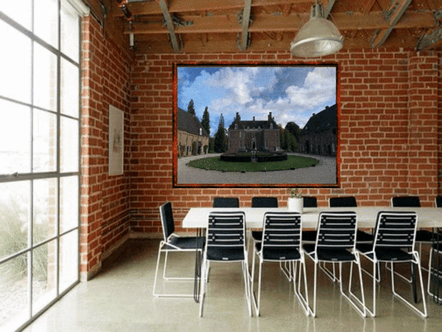 a room with a brick wall and a large picture on it