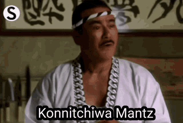 a man wearing a headband with the word konnichiwa mantz written on it