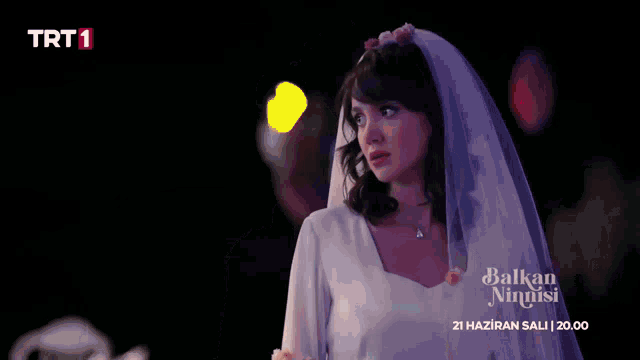 a woman in a wedding dress with a veil and trt1 on the bottom right