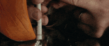 a person is smoking a cigarette with the number 996 on it