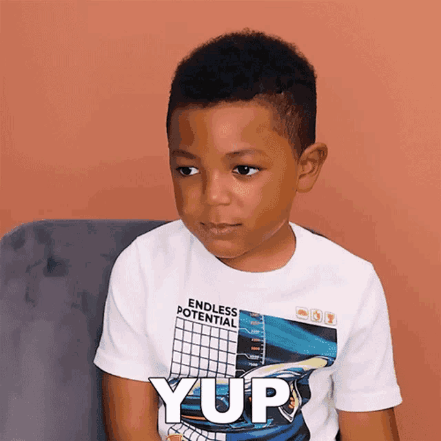 a young boy wearing a shirt that says yup on it