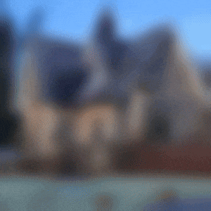 a blurry picture of a man 's head with a building in the background