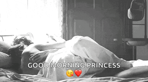 a black and white photo of a man and woman laying in bed with the words good morning princess above them .