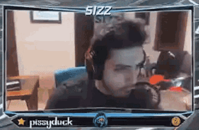 a man wearing headphones is sitting in front of a screen with the name pissyduck on it .