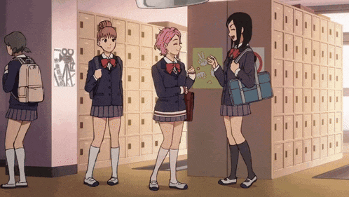 a group of girls standing in a hallway with lockers
