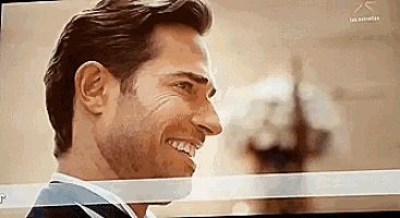 a close up of a man 's face on a television screen