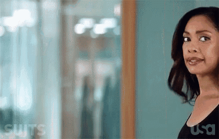 a woman is standing in front of a window in a room .