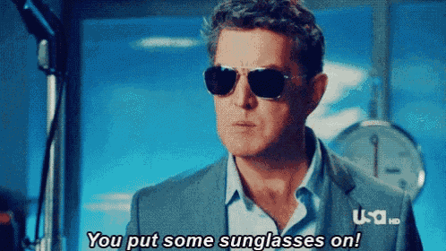 a man in a suit and sunglasses says " you put some sunglasses on "
