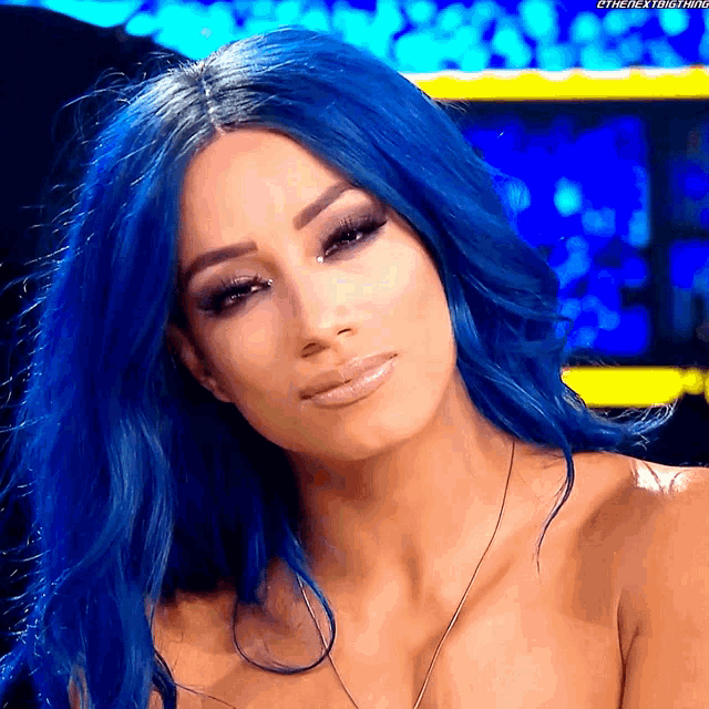 a woman with blue hair has the hashtag #thenextbig thing on her shoulder