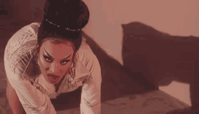 a woman in a white dress is kneeling down