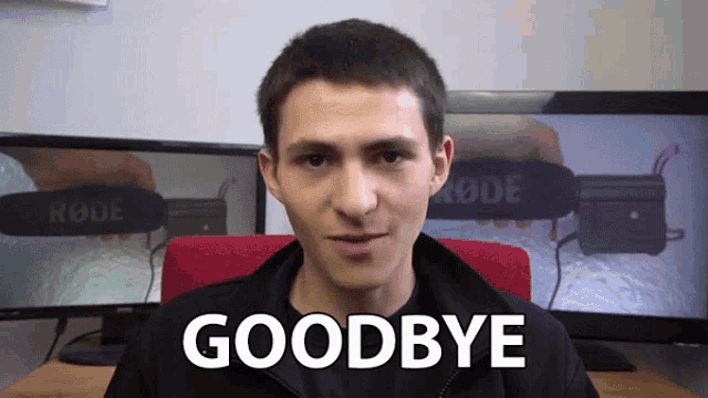 a young man says goodbye in front of a monitor