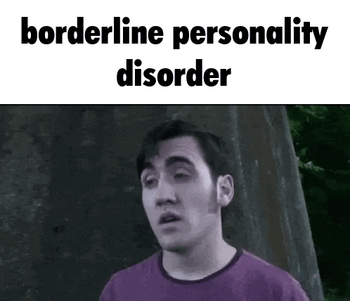 a man in a purple shirt is standing in front of a wall with the words `` borderline personality disorder '' .