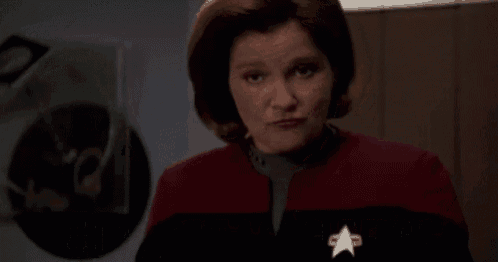 a woman in a red jacket says #like i give a single fuck