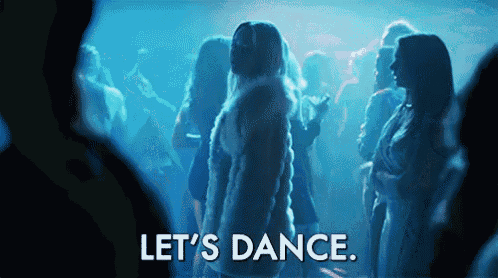 a woman in a fur coat stands in a crowd of people and says let 's dance ..