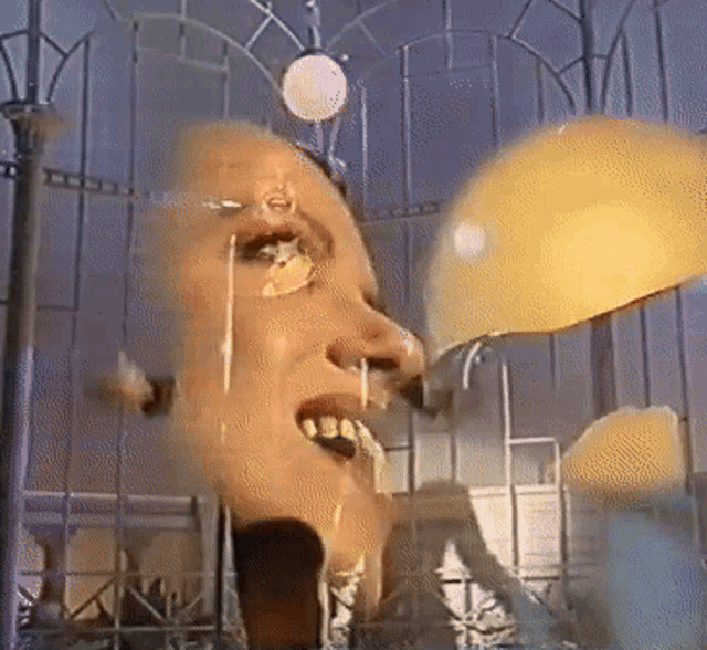 a blurred image of a woman 's face with a yellow object in the background
