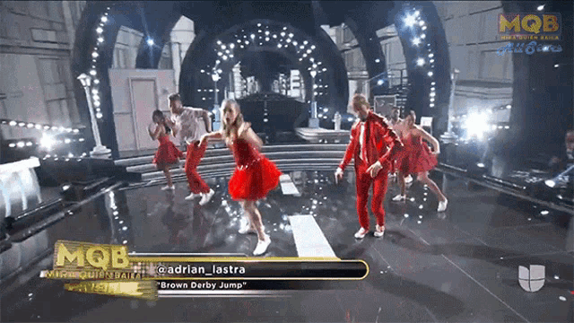 a group of people are dancing on a stage with the words mob on the bottom