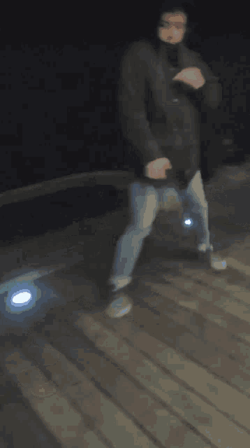 a blurry photo of a person dancing on a wooden deck