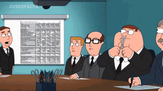 a group of men sitting around a table with a projector screen behind them that says jussdfacts
