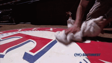 a person cleaning a sign that says fox southwest on it