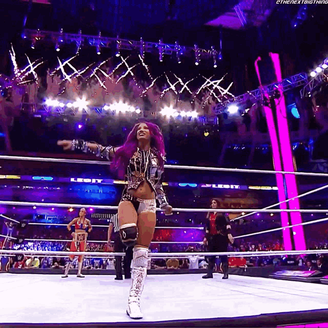 a woman with purple hair is standing in a wrestling ring with the next thing written on the bottom