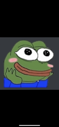 a green frog with big eyes and a pink cheek is wearing blue pants .