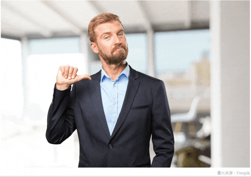 a man in a suit and blue shirt giving a thumbs down sign