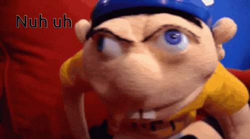 a close up of a stuffed animal with the words nuh uh written on the bottom