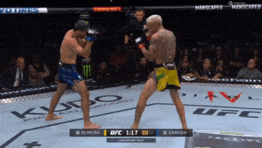 two men are fighting in a boxing ring and the ufc fight is 1:17