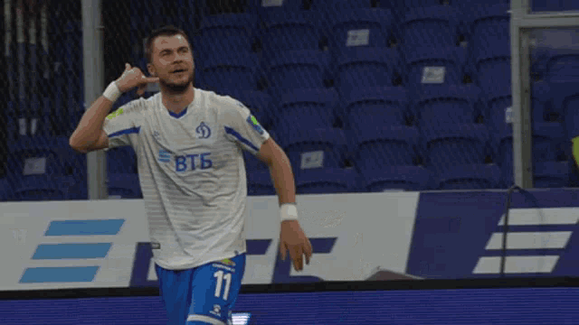 a soccer player wearing a white shirt with btb on it