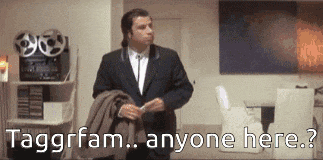 a man in a suit is standing in a room with the words taggrfam anyone here written on the bottom