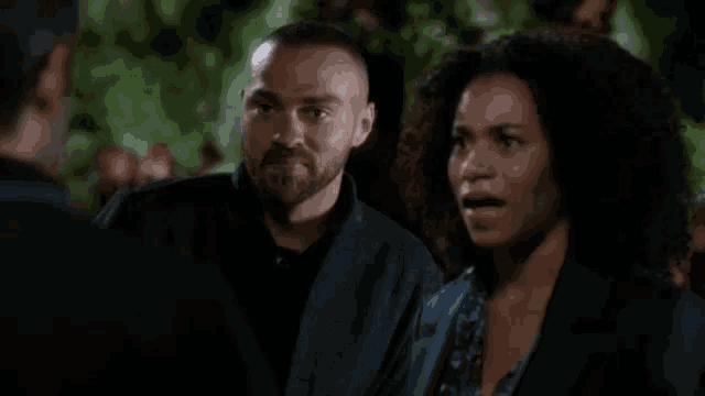 a man and a woman are standing next to each other and talking