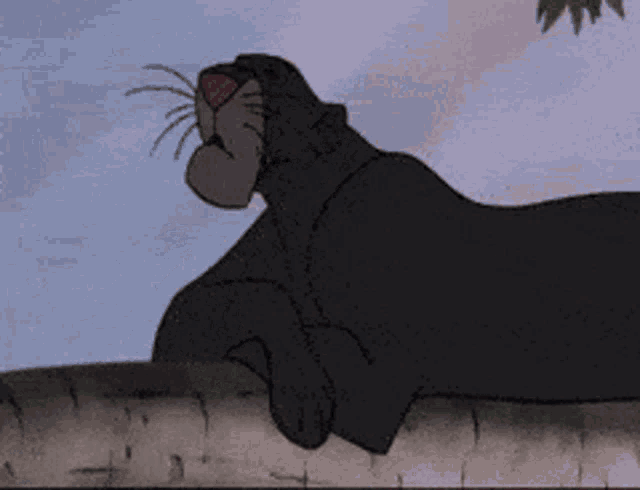 a black panther is laying on a wall with its mouth open