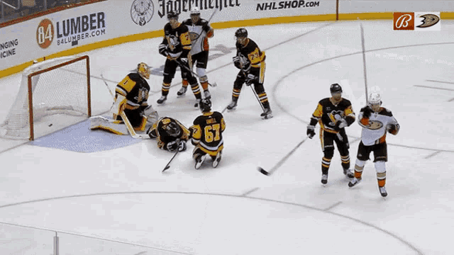 a hockey game is being played in front of a 64 lumber ad