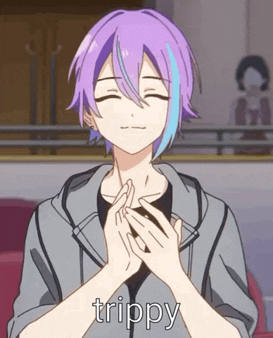 a boy with purple hair and blue streaks is holding his hands together in a prayer position .