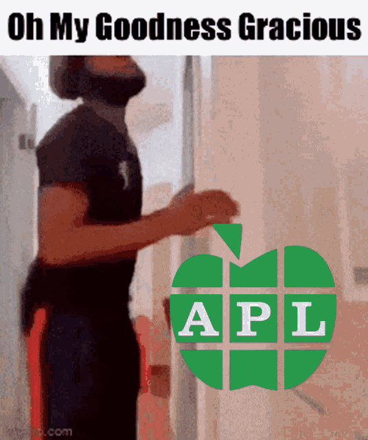 a man with a beard is standing in front of a green apple that says apl