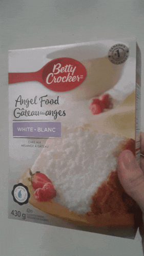 someone is holding a box of betty crocker angel food