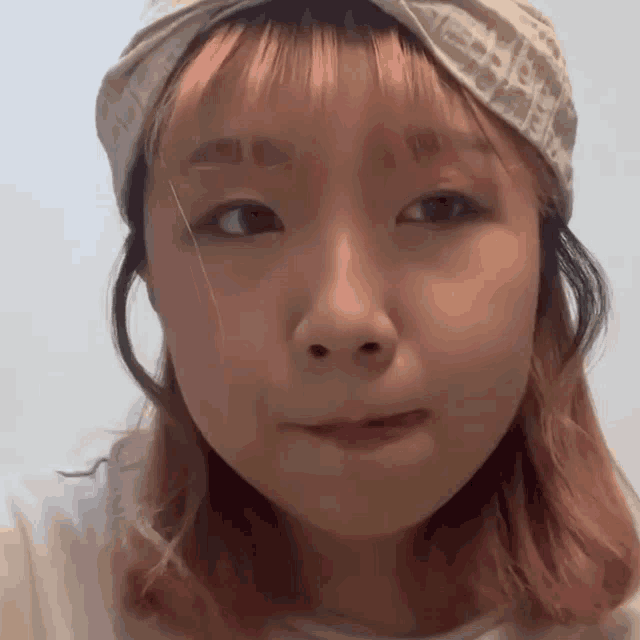 a close up of a woman wearing a headband that says dior