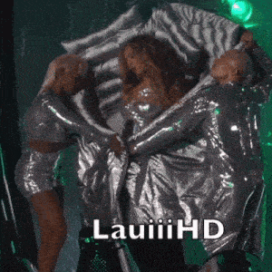 a woman in a silver dress is surrounded by two men with the words lauiii hd written on the bottom