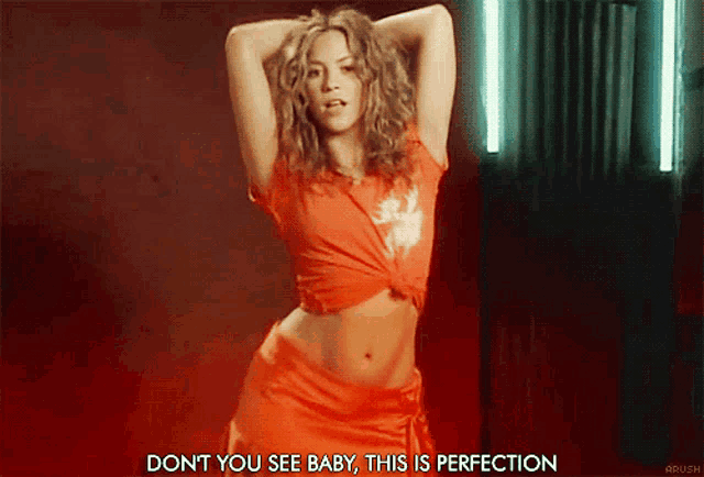 a woman in a red shirt is dancing with the words " do n't you see baby this is perfection "