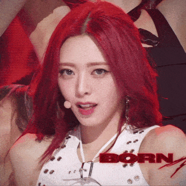 a woman with red hair is standing in front of a born sign