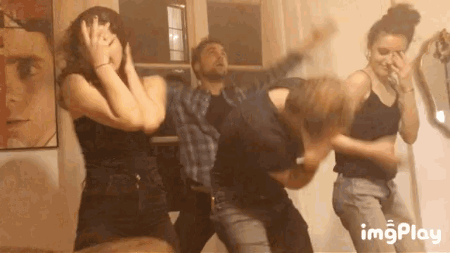 a group of people are dancing in a room with a watermark that says imgplay on the bottom